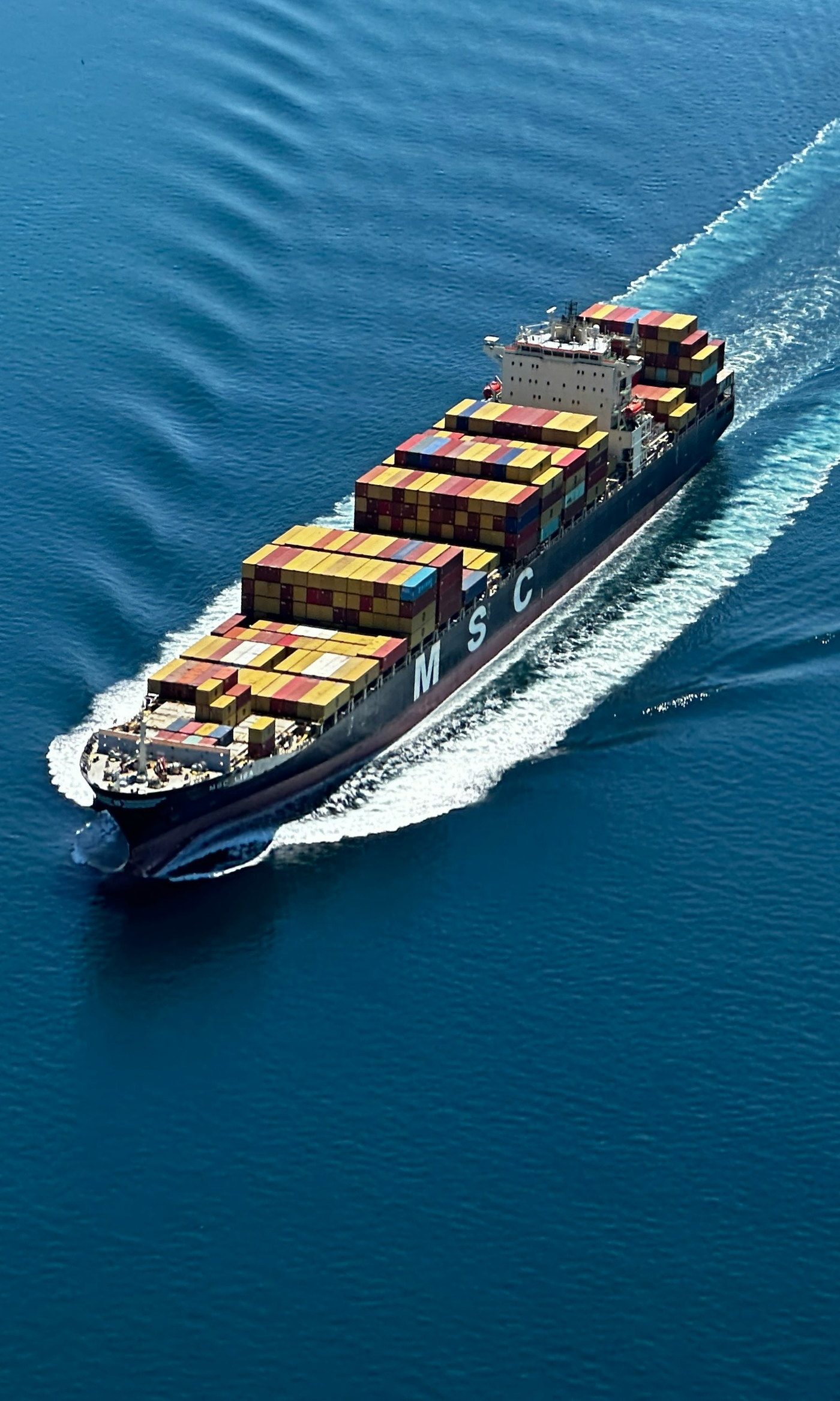 Container ship at sea, seen from the air