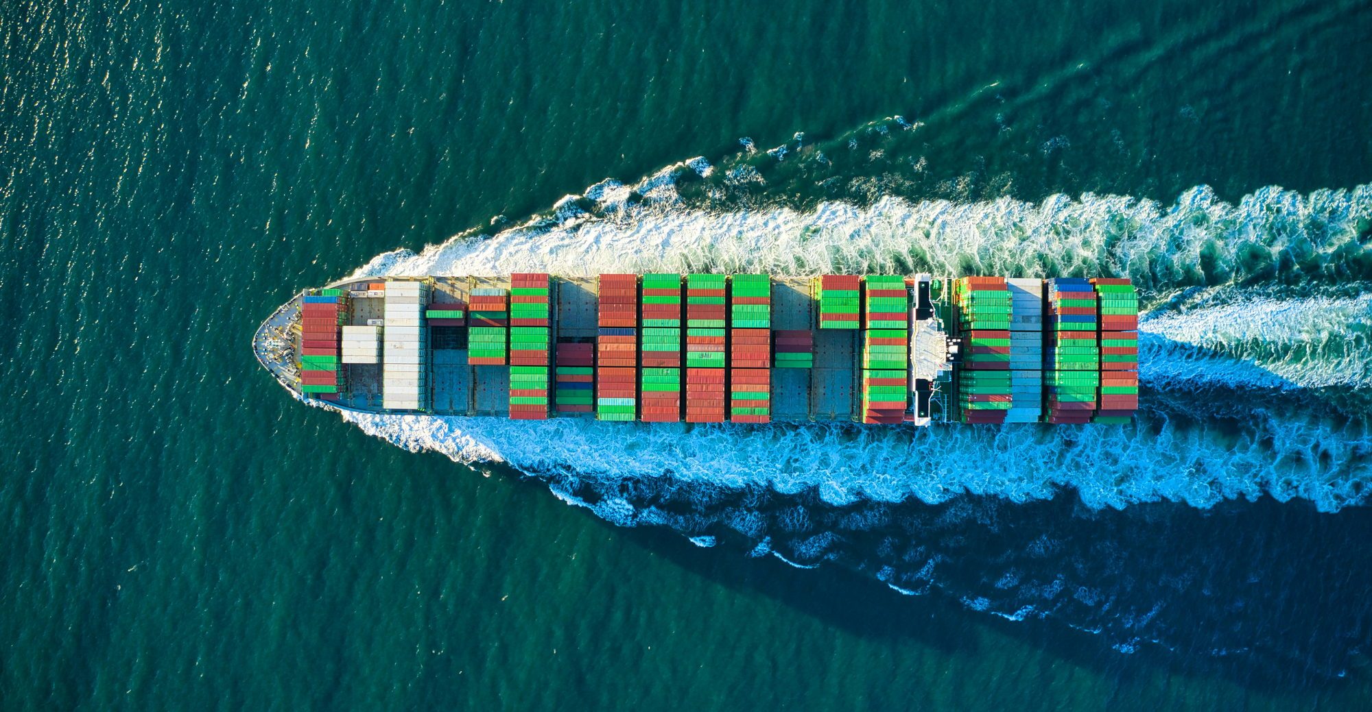 Container ship seen from directly above, with its wake